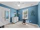 Cozy bedroom with blue walls, white trim, closet, and furniture at 6509 Virgilia Ct, Raleigh, NC 27616