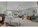 Spacious bedroom with neutral carpet, ceiling fan, a lounger and exercise bike at 6509 Virgilia Ct, Raleigh, NC 27616