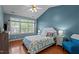 Comfortable bedroom with vaulted ceilings, hardwood floors, large windows, and designer touches at 6509 Virgilia Ct, Raleigh, NC 27616