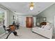 Spacious bedroom with neutral carpet, ceiling fan, a lounger and exercise bike at 6509 Virgilia Ct, Raleigh, NC 27616