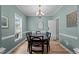 Elegant dining room features a modern chandelier, neutral paint, and large windows at 6509 Virgilia Ct, Raleigh, NC 27616