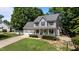 Charming two-story home with a welcoming front porch, landscaped yard, and white picket fence at 6509 Virgilia Ct, Raleigh, NC 27616