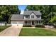 Two-story home featuring a well-maintained lawn, an attached garage, and charming curb appeal at 6509 Virgilia Ct, Raleigh, NC 27616