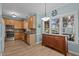 Bright kitchen with ample natural light, wooden cabinetry, stainless appliances, and stylish flooring at 6509 Virgilia Ct, Raleigh, NC 27616