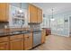 Charming kitchen featuring wood cabinets, granite countertops, and stainless steel appliances with natural light at 6509 Virgilia Ct, Raleigh, NC 27616