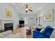 Inviting living room with fireplace, ceiling fan, hardwood floors, and natural light at 6509 Virgilia Ct, Raleigh, NC 27616