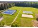 Aerial view of tennis and basketball courts, and sand volleyball providing a variety of recreational options for community members at 67 Crimson Way, Pittsboro, NC 27312