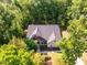 An aerial view shows the well-maintained property surrounded by lush green trees at 67 Crimson Way, Pittsboro, NC 27312