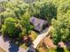 An elevated shot shows the house, driveway, and lush foliage surrounding the property at 67 Crimson Way, Pittsboro, NC 27312