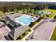 Overhead view of a community pool and tennis courts surrounded by verdant trees, recreational area, and parking at 67 Crimson Way, Pittsboro, NC 27312