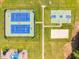 Overhead view of the community sports courts offering tennis, basketball, and sand volleyball areas with manicured green lawns at 67 Crimson Way, Pittsboro, NC 27312