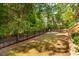 View of backyard with metal fence and rock bed at 67 Crimson Way, Pittsboro, NC 27312