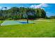 A multi-sport court awaits play under a clear blue sky, offering residents options for basketball and volleyball at 67 Crimson Way, Pittsboro, NC 27312