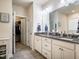 Bright bathroom boasts double vanity with granite counters and neutral paint at 67 Crimson Way, Pittsboro, NC 27312