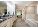 Bright bathroom boasts double vanity, glass shower and soaking tub at 67 Crimson Way, Pittsboro, NC 27312