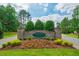 Stone entrance to The Estates Chapel Ridge with manicured landscaping and welcoming signage under a bright sky at 67 Crimson Way, Pittsboro, NC 27312