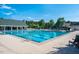 Beautiful community pool with a slide, ample seating, a covered area, and well-maintained grounds for relaxation and fun at 67 Crimson Way, Pittsboro, NC 27312