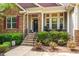 A charming exterior view of a home with a stone facade and inviting front porch at 67 Crimson Way, Pittsboro, NC 27312