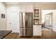 Kitchen with stainless steel refrigerator, granite countertops, white cabinets, and breakfast nook at 67 Crimson Way, Pittsboro, NC 27312