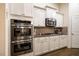 Modern kitchen with stainless steel oven, microwave, gas range, and granite countertops at 67 Crimson Way, Pittsboro, NC 27312
