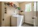 Functional laundry room equipped with washer, dryer and shelving at 67 Crimson Way, Pittsboro, NC 27312