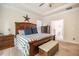 Main bedroom featuring a tray ceiling, large windows, and a wooden bed with blue pillows at 67 Crimson Way, Pittsboro, NC 27312