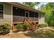 A screened porch with stairs leading to a backyard at 67 Crimson Way, Pittsboro, NC 27312