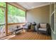 Relaxing screened porch with comfortable seating and views of the woods at 67 Crimson Way, Pittsboro, NC 27312