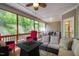 Spacious screened porch boasts ample seating, a modern fire pit, and serene views of the surrounding greenery at 67 Crimson Way, Pittsboro, NC 27312