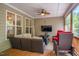 Inviting screened porch features comfortable seating, a ceiling fan, and a cozy ambiance for relaxing or entertaining at 67 Crimson Way, Pittsboro, NC 27312
