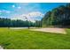 Outdoor volleyball and basketball court with green lawn and blue sky, providing community recreation for active homeowners at 67 Crimson Way, Pittsboro, NC 27312
