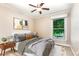 A cozy bedroom offers a ceiling fan and a large window to the outside at 6820 Chamonix Pl, Raleigh, NC 27613