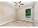 Cozy bedroom with beige walls, a ceiling fan, carpet flooring and a bright window at 6820 Chamonix Pl, Raleigh, NC 27613