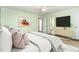 A spacious bedroom features light green walls, neutral furnishings and an ensuite bathroom at 6820 Chamonix Pl, Raleigh, NC 27613