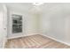 Cozy bedroom with white walls, ceiling fan, carpet flooring, and a bright window with blinds at 6820 Chamonix Pl, Raleigh, NC 27613