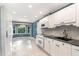Bright kitchen featuring white cabinets, a black countertop, tile backsplash, and stainless appliances at 6820 Chamonix Pl, Raleigh, NC 27613