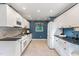 The galley kitchen showcases granite counters, white cabinets, and stainless appliances at 6820 Chamonix Pl, Raleigh, NC 27613