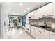 Kitchen featuring stainless appliances, white cabinetry, and an adjacent dining area at 6820 Chamonix Pl, Raleigh, NC 27613