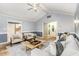 Inviting living room boasts a vaulted ceiling, ceiling fan and neutral color palette at 6820 Chamonix Pl, Raleigh, NC 27613