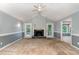 Spacious living room featuring a fireplace, neutral carpet, and access to the backyard at 6820 Chamonix Pl, Raleigh, NC 27613