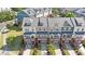 Scenic aerial view of townhomes with brick accents, private balconies, and neat landscaping in a residential community at 710 Samuel Cary Dr, Cary, NC 27511