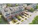 Aerial shot showcasing colorful townhomes with landscaped yards, private garages, and front porches at 710 Samuel Cary Dr, Cary, NC 27511