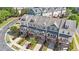 Aerial view of colorful townhouses with front porches, driveways, landscaping, and green spaces at 710 Samuel Cary Dr, Cary, NC 27511