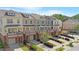 Aerial view of colorful townhomes with garages, porches, landscaped yards, and mature trees at 710 Samuel Cary Dr, Cary, NC 27511