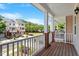 Charming balcony with porch railing overlooking the neighborhood and blue skies at 710 Samuel Cary Dr, Cary, NC 27511