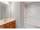Well-lit bathroom featuring a shower-tub combo and a vanity with a sink at 710 Samuel Cary Dr, Cary, NC 27511