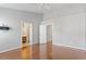 Spacious bedroom with hardwood floors, ceiling fan, and ensuite bathroom at 710 Samuel Cary Dr, Cary, NC 27511