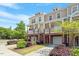 Exterior view of townhomes featuring colorful siding, balconies, and mature trees at 710 Samuel Cary Dr, Cary, NC 27511
