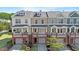 Colorful townhomes featuring brick facades, front porches, individual garages, and dormer windows at 710 Samuel Cary Dr, Cary, NC 27511