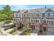 Exterior view of charming townhomes with colorful facades, garages, and landscaped front yards at 710 Samuel Cary Dr, Cary, NC 27511
